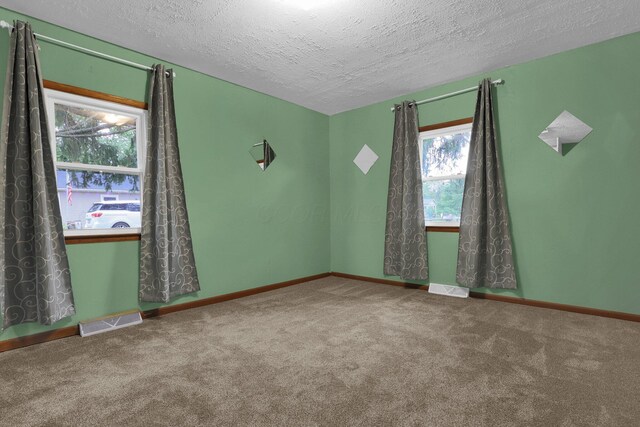 13424 Ivy Rd NE, Thornville, OH 43076 - spare room featuring carpet floors and a textured ceiling