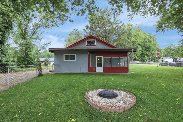 13424 Ivy Rd NE, Thornville, OH 43076 - back of property with a fenced backyard and an outdoor fire pit