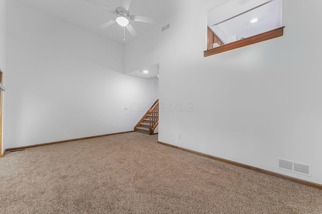 406 Olentangy Forest Dr Unit 9B, Columbus, OH 43214 - carpeted spare room with stairway, baseboards, a ceiling fan, and a high ceiling
