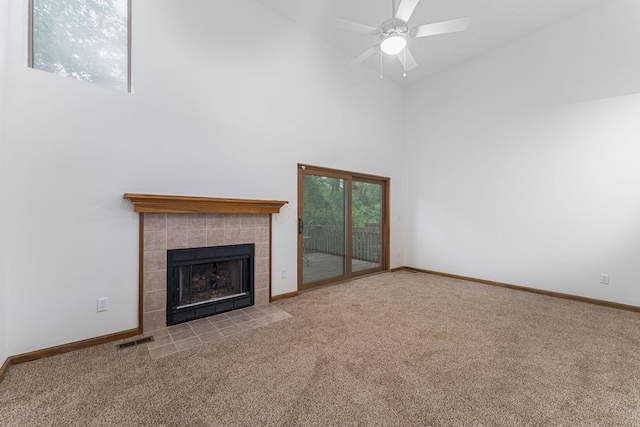406 Olentangy Forest Dr Unit 9B, Columbus, OH 43214 - unfurnished living room with high vaulted ceiling, carpet, a tiled fireplace, baseboards, and ceiling fan