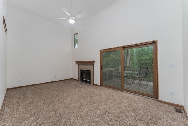 406 Olentangy Forest Dr Unit 9B, Columbus, OH 43214 - unfurnished living room featuring carpet floors, high vaulted ceiling, a tiled fireplace, baseboards, and a ceiling fan