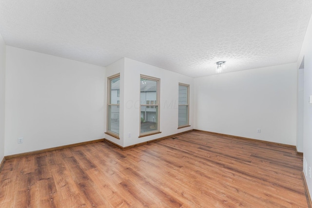 406 Olentangy Forest Dr Unit 9B, Columbus, OH 43214 - empty room featuring light wood-style flooring, baseboards, and a textured ceiling