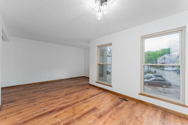 406 Olentangy Forest Dr Unit 9B, Columbus, OH 43214 - bonus room featuring wood finished floors, a textured ceiling, and baseboards