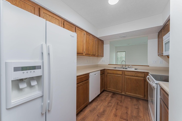 406 Olentangy Forest Dr Unit 9B, Columbus, OH 43214 - kitchen featuring white appliances, a sink, dark wood-style floors, brown cabinetry, and light countertops