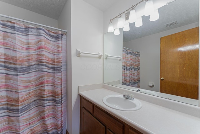 406 Olentangy Forest Dr Unit 9B, Columbus, OH 43214 - bathroom with a textured ceiling, vanity, and a shower with shower curtain