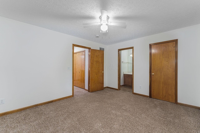406 Olentangy Forest Dr Unit 9B, Columbus, OH 43214 - unfurnished bedroom with light colored carpet, baseboards, ensuite bathroom, ceiling fan, and a textured ceiling