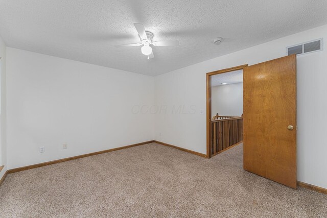 406 Olentangy Forest Dr Unit 9B, Columbus, OH 43214 - spare room featuring carpet floors, a ceiling fan, baseboards, a textured ceiling, and a smoke detector