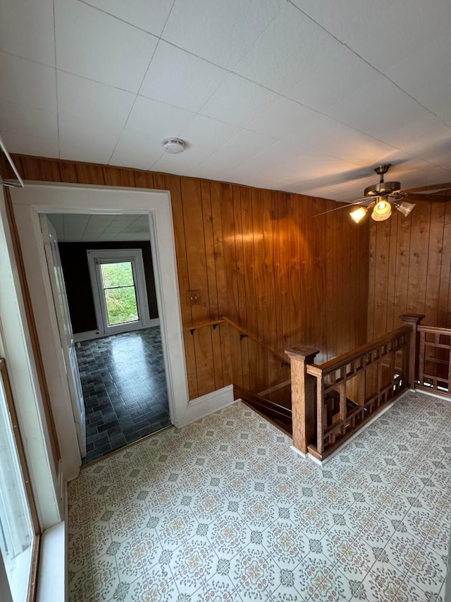 627 N Main St, Utica, OH 43080 - empty room with wooden walls, a smoke detector, and a ceiling fan