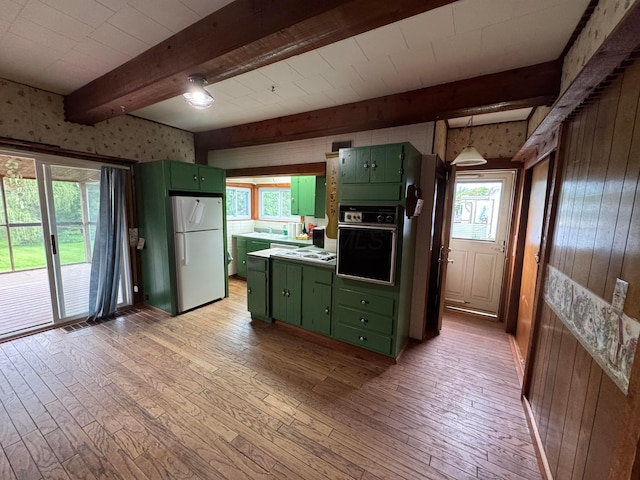627 N Main St, Utica, OH 43080 - kitchen featuring green cabinets, white appliances, beam ceiling, wood walls, and light wood finished floors