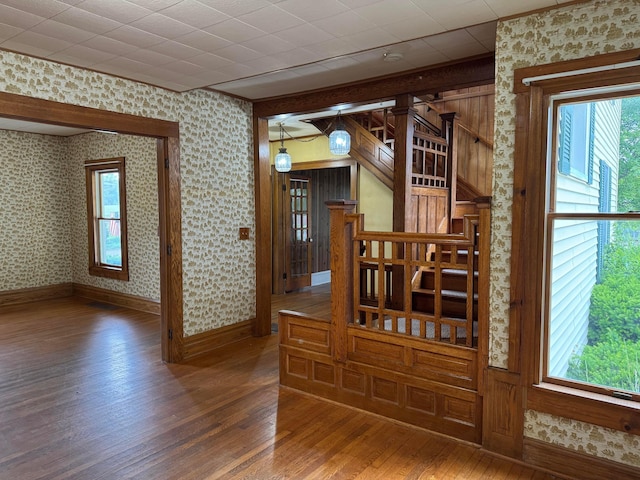 627 N Main St, Utica, OH 43080 - stairs featuring wood finished floors, plenty of natural light, baseboards, and wallpapered walls