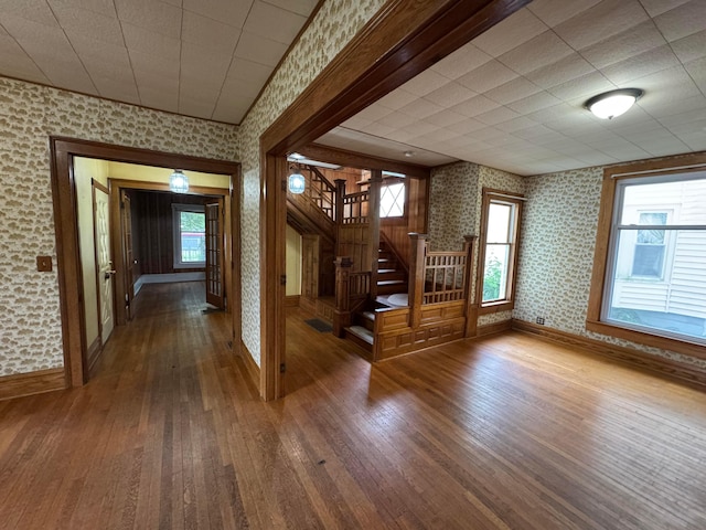 627 N Main St, Utica, OH 43080 - hallway with wallpapered walls, hardwood / wood-style floors, baseboards, and stairway