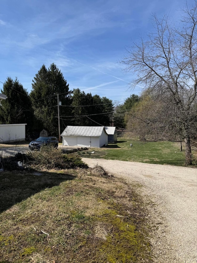 627 N Main St, Utica, OH 43080 - view of grassy yard with an outbuilding and dirt driveway