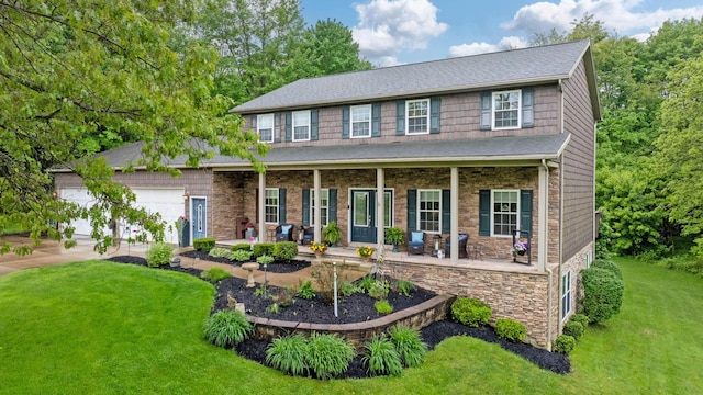 15027 King Rd, Howard, OH 43028 - colonial home with covered porch, a front yard, stone siding, a garage, and concrete driveway