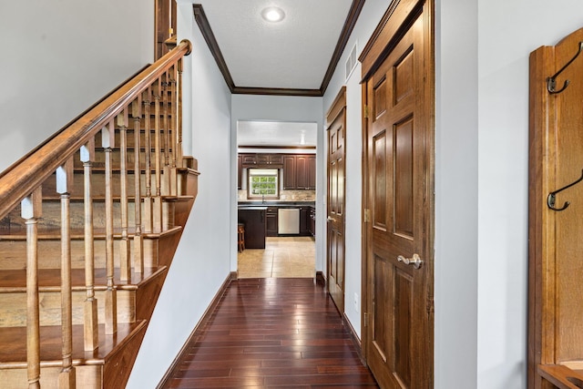 15027 King Rd, Howard, OH 43028 - hall with ornamental molding, dark wood finished floors, stairs, and baseboards