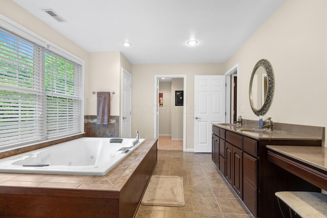 15027 King Rd, Howard, OH 43028 - bathroom featuring a jetted tub, double vanity, tile patterned floors, baseboards, and recessed lighting