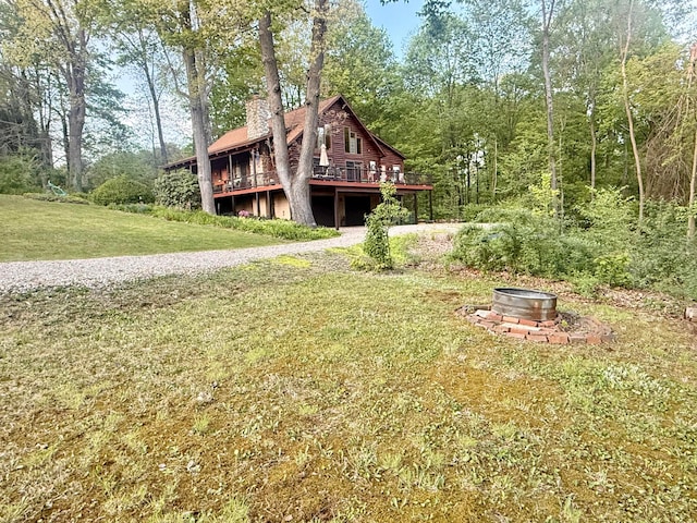 15626 Pleasant View Dr, Mount Vernon, OH 43050 - view of front facade with a chimney, an outdoor fire pit, a deck, and a front yard