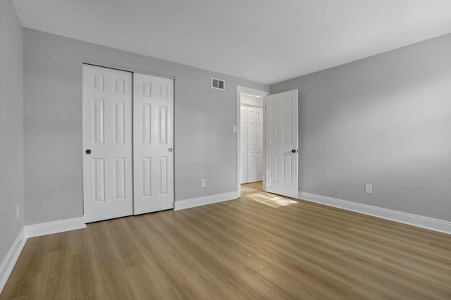 4230 Reed Rd, Columbus, OH 43220 - unfurnished bedroom featuring baseboards, light wood-style floors, and a closet