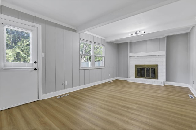 4230 Reed Rd, Columbus, OH 43220 - unfurnished living room featuring wood finished floors, beamed ceiling, a fireplace, and baseboards