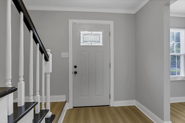 4230 Reed Rd, Columbus, OH 43220 - entrance foyer with light wood-style flooring, stairs, plenty of natural light, crown molding, and baseboards