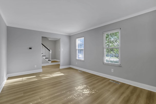 4230 Reed Rd, Columbus, OH 43220 - spare room featuring crown molding, stairway, wood finished floors, and baseboards