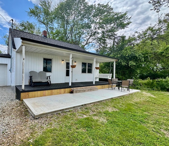 4425 Ashville Fairfield Rd, Ashville, OH 43103 - back of house with a yard, a chimney, a porch, and a patio area