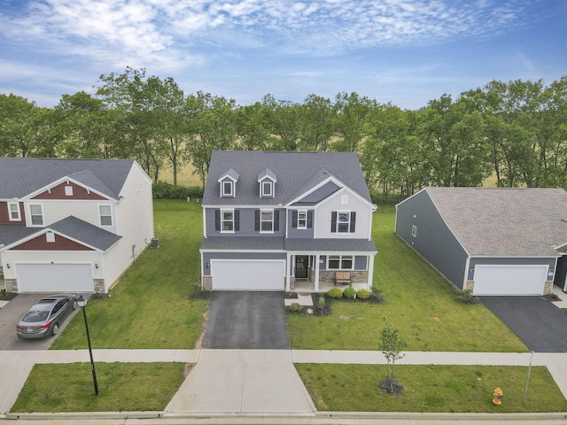 233 Dowler Dr, South Bloomfield, OH 43103 - traditional home with covered porch, a front yard, asphalt driveway, and a garage
