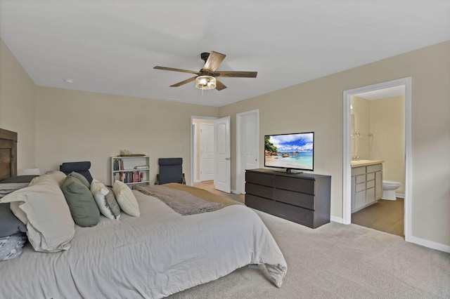 233 Dowler Dr, South Bloomfield, OH 43103 - carpeted bedroom featuring baseboards, connected bathroom, and ceiling fan