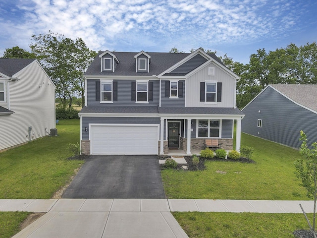 233 Dowler Dr, South Bloomfield, OH 43103 - craftsman-style house with driveway, a front lawn, an attached garage, and covered porch
