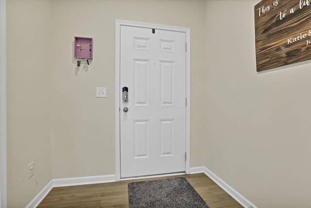 233 Dowler Dr, South Bloomfield, OH 43103 - doorway with baseboards and dark wood-style floors