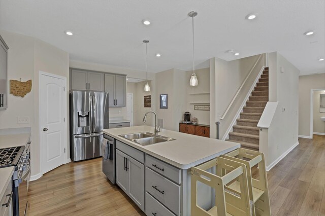 233 Dowler Dr, South Bloomfield, OH 43103 - kitchen with a sink, gray cabinets, stainless steel appliances, light wood-type flooring, and recessed lighting