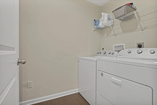 233 Dowler Dr, South Bloomfield, OH 43103 - washroom featuring washing machine and dryer, baseboards, and dark wood-style flooring