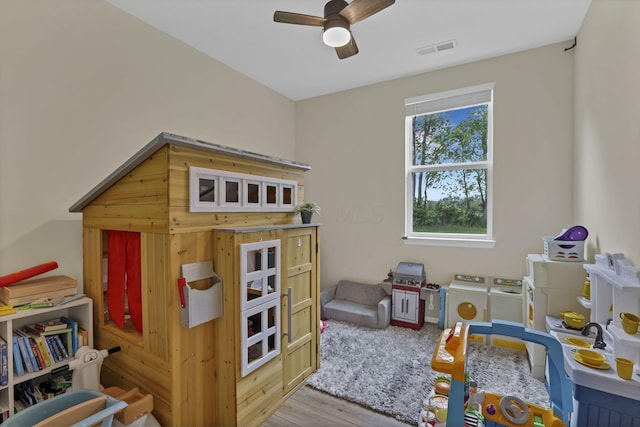 233 Dowler Dr, South Bloomfield, OH 43103 - recreation room with separate washer and dryer, a ceiling fan, and wood finished floors