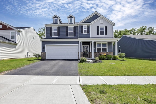 233 Dowler Dr, South Bloomfield, OH 43103 - view of front facade with driveway, a front lawn, an attached garage, board and batten siding, and stone siding