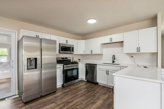 4795 Hafey Ave, Columbus, OH 43228 - kitchen with stainless steel appliances, a sink, dark wood-type flooring, and decorative backsplash
