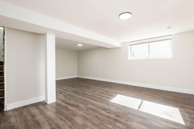 4795 Hafey Ave, Columbus, OH 43228 - basement with baseboards, dark wood finished floors, and stairs