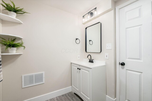 4795 Hafey Ave, Columbus, OH 43228 - bathroom featuring vanity, baseboards, and wood finished floors