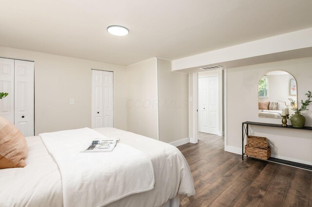 4795 Hafey Ave, Columbus, OH 43228 - bedroom featuring dark wood-style floors, multiple closets, and baseboards