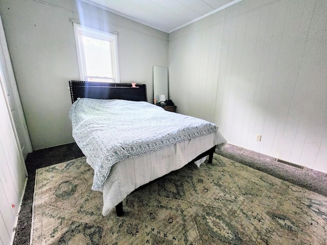 750 S 9th St, Cambridge, OH 43725 - carpeted bedroom with crown molding and wood walls