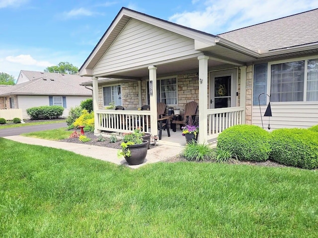 154 Pioneer Cir, Pickerington, OH 43147 - view of front of property featuring covered porch, a front lawn, stone siding, and a shingled roof