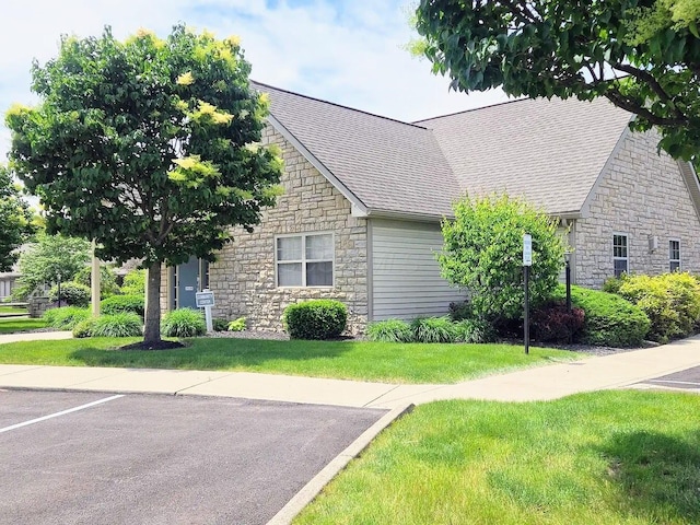154 Pioneer Cir, Pickerington, OH 43147 - view of front of property with stone siding, a front lawn, and a shingled roof