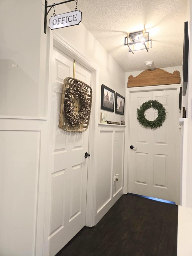 154 Pioneer Cir, Pickerington, OH 43147 - doorway with a textured ceiling and dark wood-type flooring