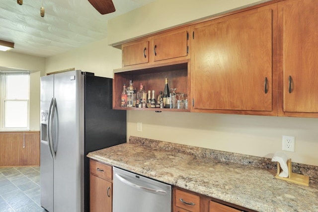 2320 Miller Paul Rd, Galena, OH 43021 - kitchen featuring stainless steel appliances, brown cabinets, light stone counters, and ceiling fan