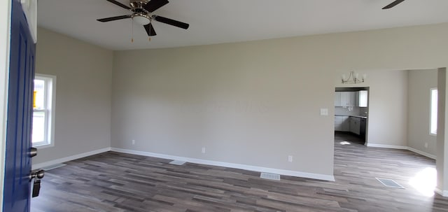16 W Walnut St, Jeffersonville, OH 43128 - unfurnished room featuring ceiling fan, dark wood finished floors, baseboards, and a chandelier
