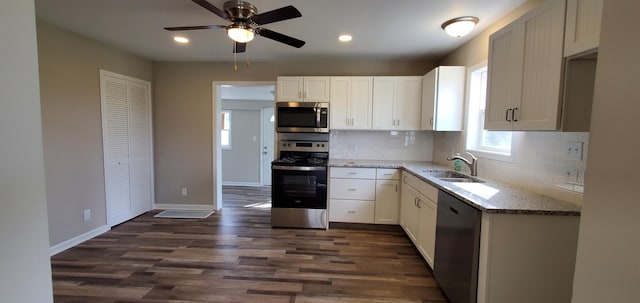 16 W Walnut St, Jeffersonville, OH 43128 - kitchen with appliances with stainless steel finishes, a sink, backsplash, light stone countertops, and baseboards