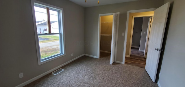 16 W Walnut St, Jeffersonville, OH 43128 - unfurnished bedroom with multiple windows, carpet floors, baseboards, and a closet