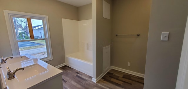 16 W Walnut St, Jeffersonville, OH 43128 - bathroom with wood finished floors, vanity, baseboards, and  shower combination