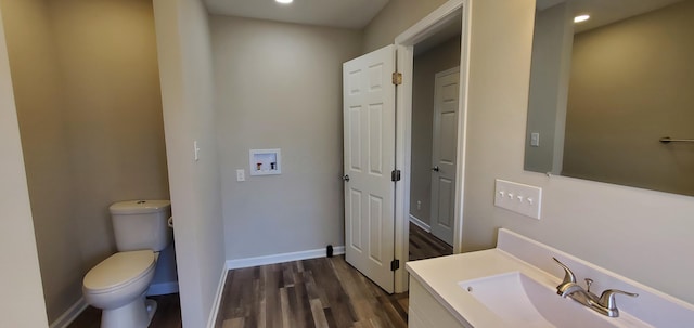 16 W Walnut St, Jeffersonville, OH 43128 - bathroom featuring toilet, vanity, wood finished floors, recessed lighting, and baseboards