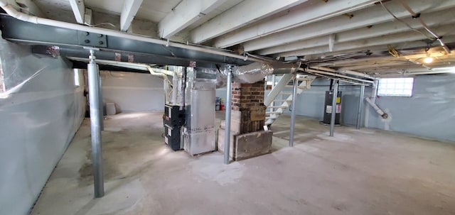 16 W Walnut St, Jeffersonville, OH 43128 - basement with water heater, heating unit, and stairway