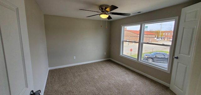 16 W Walnut St, Jeffersonville, OH 43128 - spare room with light carpet, baseboards, and ceiling fan