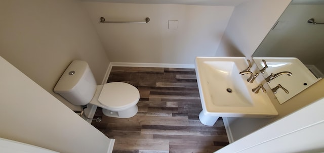 16 W Walnut St, Jeffersonville, OH 43128 - bathroom featuring wood finished floors, toilet, and a sink